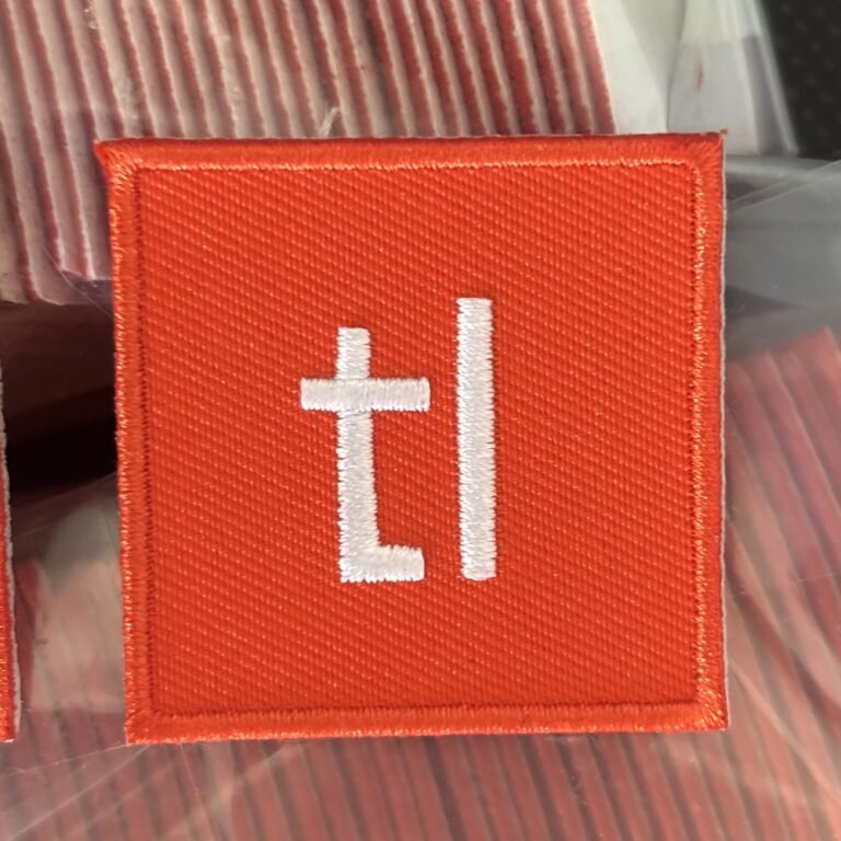The Techleap logo as a finished embroidered iron-on patch